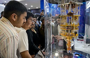 Source : PTI : Visitors at a stall during the AI Impact Summit, at Bharat Mandapam, in New Delhi, Wednesday, Feb. 18, 2026.