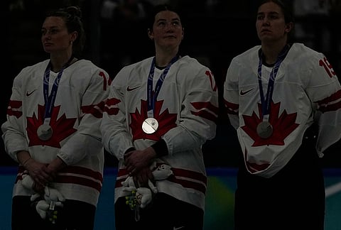 The silver medal on Canada's Ella Shelton reflects during medals ceremony at the 2026 Winter Olympics, in Milan, Italy.