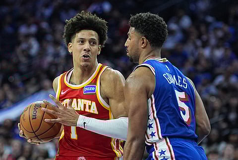 Atlanta Hawks' Jalen Johnson, left, tries to get a shot past Philadelphia 76ers' Quentin Grimes (5) during the first half of an NBA basketball game in Philadelphia.