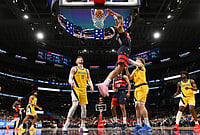 Washington Vs Indiana NBA: Wizards Outlast Pacers In Capital One Arena Thriller - In Pics | Photo: AP/Nick Wass : Washington Wizards guard Alondes Williams (31) reverse dunks over Indiana Pacers center Micah Potter (11) and guard Taelon Peter (4) during the second half of an NBA basketball game in Washington.