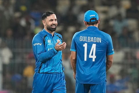 Afghanistan's Mohammad Nabi, left, and Gulbadin Naib celebrates the wicket of Canada's Harsh Thaker during the T20 World Cup cricket match between Afghanistan and Canada in Chennai.