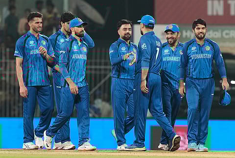 Afghanistan's players celebrate after winning the T20 World Cup cricket match against Canada in Chennai.