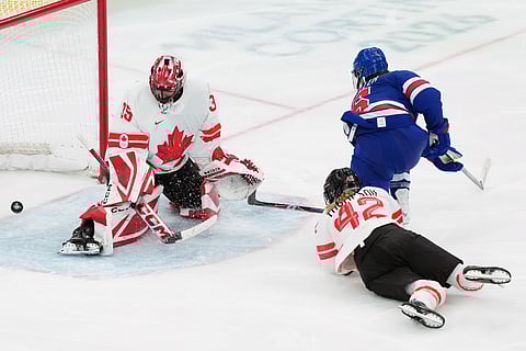 United States' Megan Keller (5) scores the winning goal against Canada goalkeeper Ann-Renee Desbiens (35) during the overtime period of the women's ice hockey gold medal game at the 2026 Winter Olympics in Milan, Italy, Thursday, Feb. 19, 2026.