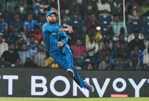 Afghanistan's Mohammad Nabi throws the ball after fielding during the T20 World Cup cricket match between Afghanistan and Canada in Chennai.