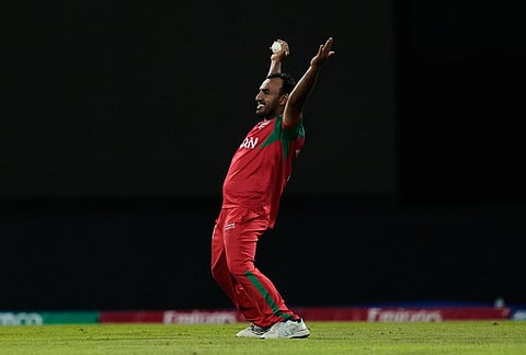 Oman's Shakeel Ahamed celebrates after taking the catch of Australia's Travis Head during the T20 World Cup cricket match between Australia and Oman in Pallekele, Sri Lanka.