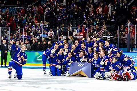 United States' Megan Keller, left, who scored the game winning goal in overtime, takes a selfie with teammates as they celebrate after defeating Canada in the women's ice hockey gold medal game at the 2026 Winter Olympics in Milan, Italy, Thursday, Feb. 19, 2026. 