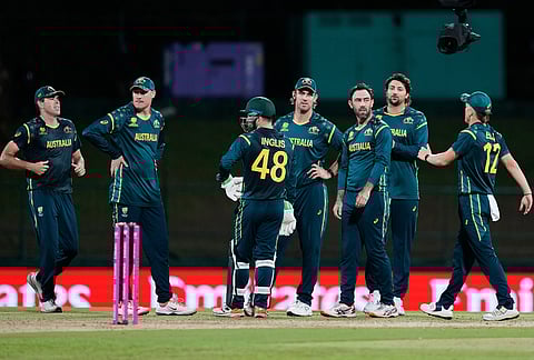 Australia's Glenn Maxwell, centre, celebrates with teammates the wicket of Oman's Jiten Ramanandi during the T20 World Cup cricket match between Australia and Oman in Pallekele, Sri Lanka.