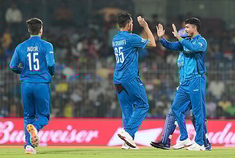 Afghanistan's Mujeeb Ur Rahman celebrates with teammates the wicket of Canada's captain Dilpreet Bajwa during the T20 World Cup cricket match between Afghanistan and Canada in Chennai.