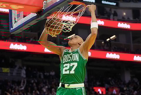 Boston Celtics guard Jordan Walsh (27) dunks against the Golden State Warriors during the first half of an NBA basketball game in San Francisco.