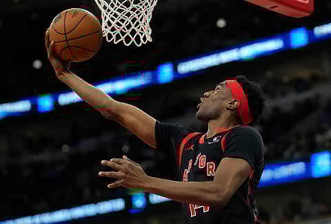 Toronto Raptors guard Ja'kobe Walter (14) makes a shot during the second half of an NBA basketball game against the Chicago Bulls in Chicago.
