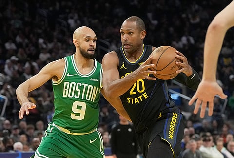 Golden State Warriors center Al Horford (20) drives to the basket against Boston Celtics guard Derrick White (9) during the first half of an NBA basketball game in San Francisco.
