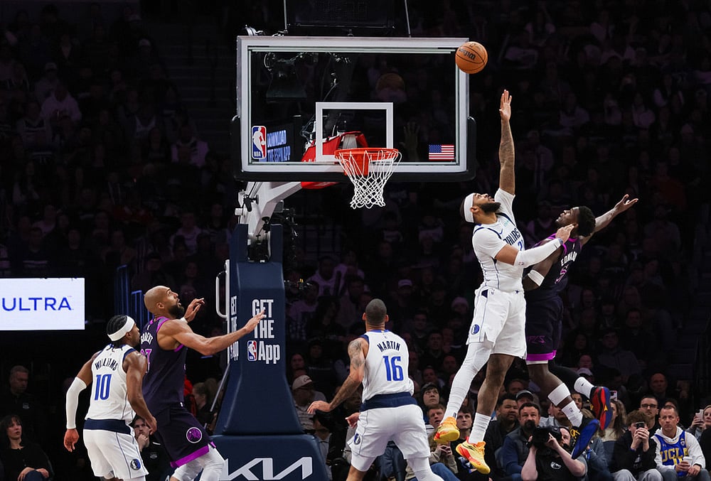 Dallas Mavericks' Daniel Gafford, second from right, leaps to block a shot by Minnesota Timberwolves' Anthony Edwards, right, during the second half of an NBA basketball game in Minneapolis.  - | Photo: AP/Lily Dozier