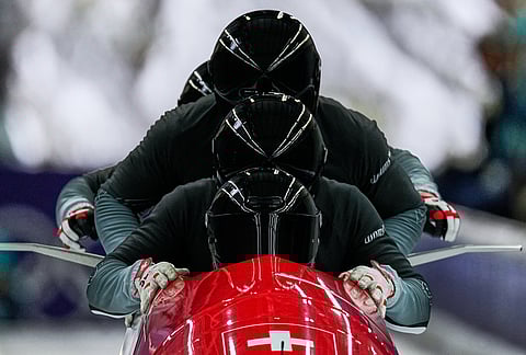 Switzerland's Michael Vogt, front, starts for a four man bobsled training session at the 2026 Winter Olympics, in Cortina d'Ampezzo, Italy.