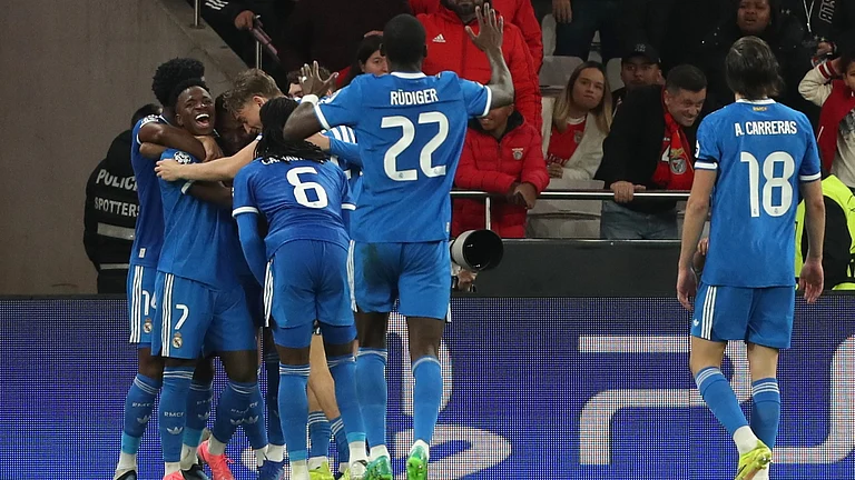 Real Madrid's Vinicius Junior celebrates with team mates the opening goal during a Champions League playoff soccer match between SL Benfica and Real Madrid in Lisbon, Portugal, Tuesday, Feb. 17, 2026. - | Photo: AP/Pedro Rocha