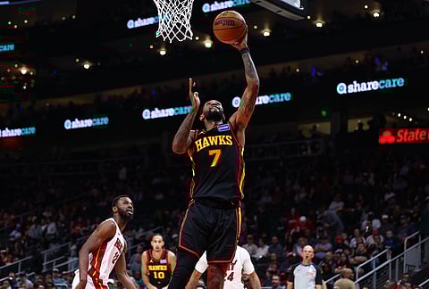 Atlanta Hawks guard Nickeil Alexander-Walker (7) shoots against Miami Heat forward Andrew Wiggins, left, during the first half of an NBA basketball game, in Atlanta.