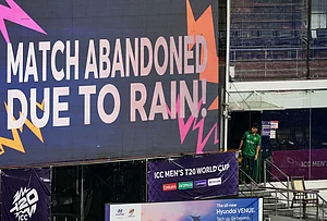 | Photo: AP/Eranga Jayawardena : Pakistan's Usman Khan looks at a large screen announcing that the T20 World Cup cricket match between New Zealand and Pakistan is abandoned due to rain, in Colombo, Sri Lanka.