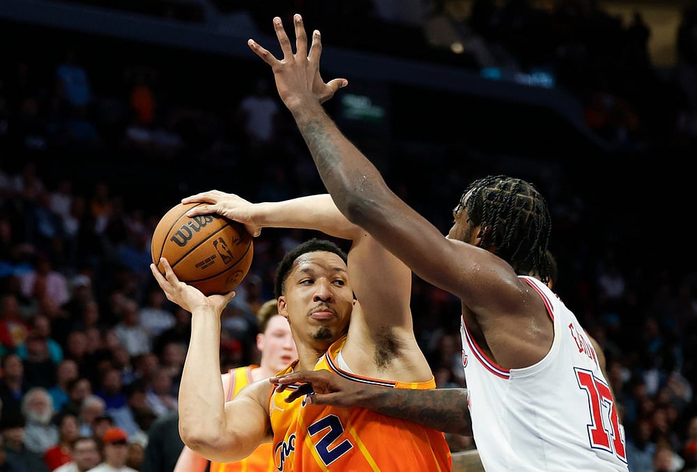 | Photo: AP/Nell Redmon : Charlotte Hornets forward Grant Williams (2) looks to pass the ball against Houston Rockets forward Tari Eason, right, during the second half of an NBA basketball game in Charlotte, North Carolina.