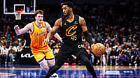 Donovan Mitchell #45 of the Cleveland Cavaliers drives by Kon Knueppel #7 of the Charlotte Hornets during the first half of a basketball game at Spectrum Center on February 20, 2026 in Charlotte, North Carolina.