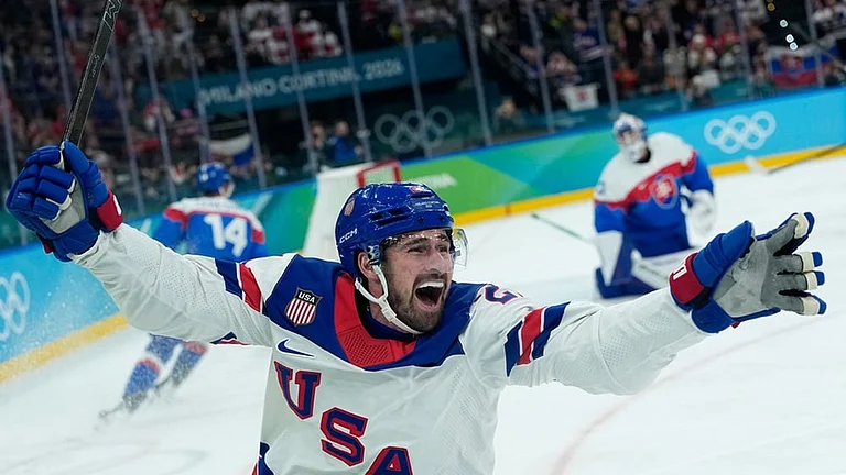 United States' Dylan Larkin (21) celebrates after scoring the opening goal during a men's ice hockey semifinal game between United States and Slovakia at the 2026 Winter Olympics, in Milan, Italy. - | Photo: AP/Petr David Josek
