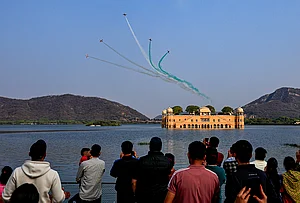 | Photo: PTI : Indian Air Force's (IAF) Surya Kiran Aerobatic Team (SKAT) performs manoeuvres over the Jal Mahal during full dress rehearsal ahead of the Sarang and Surya Kiran Air Show, in Jaipur, Rajasthan.