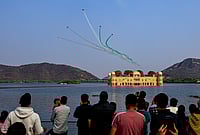 Day In Pics: February 20, 2026 | Photo: PTI : Indian Air Force's (IAF) Surya Kiran Aerobatic Team (SKAT) performs manoeuvres over the Jal Mahal during full dress rehearsal ahead of the Sarang and Surya Kiran Air Show, in Jaipur, Rajasthan.