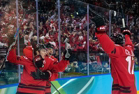Canada's Nathan MacKinnon (29) celebrates with teammates after scoring his side's third goal during a men's ice hockey semifinal game between Canada and Finland at the 2026 Winter Olympics, in Milan, Italy.