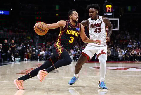 Atlanta Hawks guard CJ McCollum (3) dribbles against Miami Heat guard Davion Mitchell (45) during the first half of an NBA basketball game, in Atlanta. 