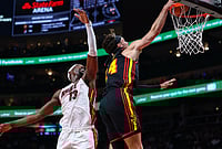| Photo: AP/Colin Hubbard : Atlanta Hawks forward Corey Kispert, right, dunks against Miami Heat center Bam Adebayo, left, during the first half of an NBA basketball game, in Atlanta. 
