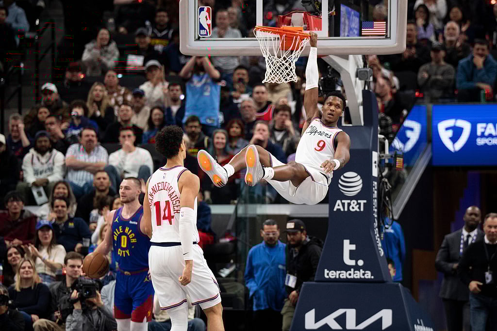 | Photo: AP/Kyusung Gong : Los Angeles Clippers guard Bennedict Mathurin (9) hangs onto the rim after dunking during the second half of an NBA basketball game against the Denver Nuggets in Inglewood, California. 