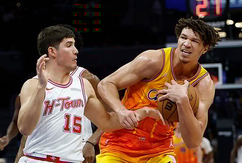 Charlotte Hornets forward Tidjane Salaun, right, drives to the basket against Houston Rockets guard Reed Sheppard, left, during the second half of an NBA basketball game in Charlotte, North Carolina.
