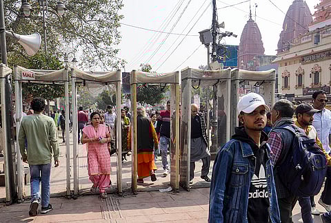 People pass through metal detectors installed near the Red Fort amid heightened security following intelligence inputs about a suspected IED threat in the Chandni Chowk area, in New Delhi.