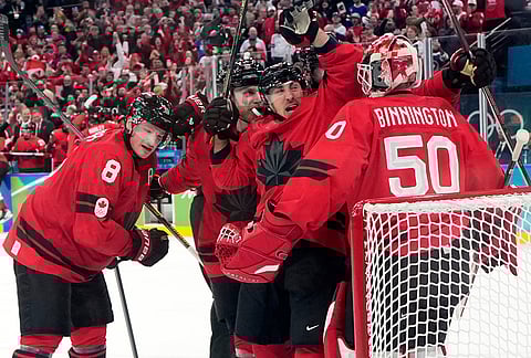 Canada players celebrate at the end of a men's ice hockey semifinal game between Canada and Finland at the 2026 Winter Olympics, in Milan, Italy.