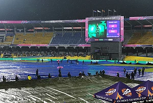 | Photo: AP/Eranga Jayawardena : Groundsmen cover the field as it begins to rain before the start of the T20 World Cup cricket match between New Zealand and Pakistan in Colombo, Sri Lanka.