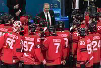 | Photo: AP/Carolyn Kaster : Canada head coach Jon Cooper talks with his players after their win against Finland in a men's ice hockey semifinal game at the 2026 Winter Olympics in Milan, Italy.