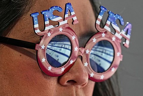 A United States supporter watches a women's curling semifinal match between Switzerland and the United States, at the 2026 Winter Olympics, in Cortina d'Ampezzo, Italy.