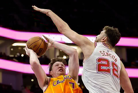 Charlotte Hornets guard Kon Knueppel (7) shoots against Houston Rockets center Alperen Sengun during the second half of an NBA basketball game in Charlotte, North Carolina.