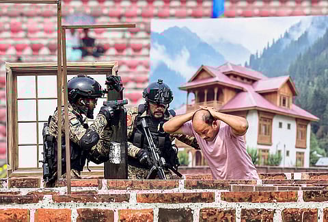 CRPF personnel take part in a mock drill during the 87th Raising Day Parade of the Central Reserve Police Force, in Guwahati.
