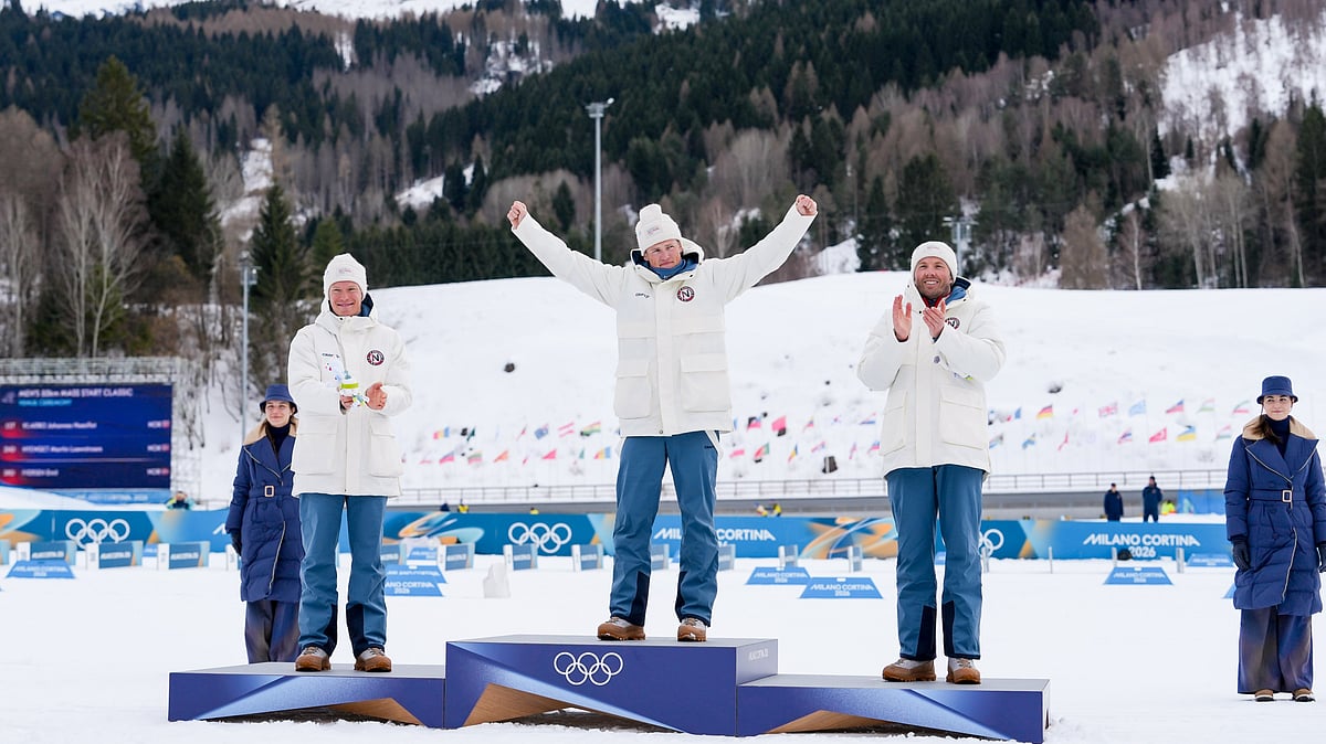 Silver medalist Martin Loewstroem Nyenget, gold medalist Johannes Hoesflot Klaebo and bronze medalist Emil Iversen, all three of Norway, stand on the podium of the cross country skiing men's 50km mass start Classic at the 2026 Winter Olympics, in Tesero, Italy, Saturday, Feb. 21, 2026. - | Photo: AP/Evgeniy Maloletka
