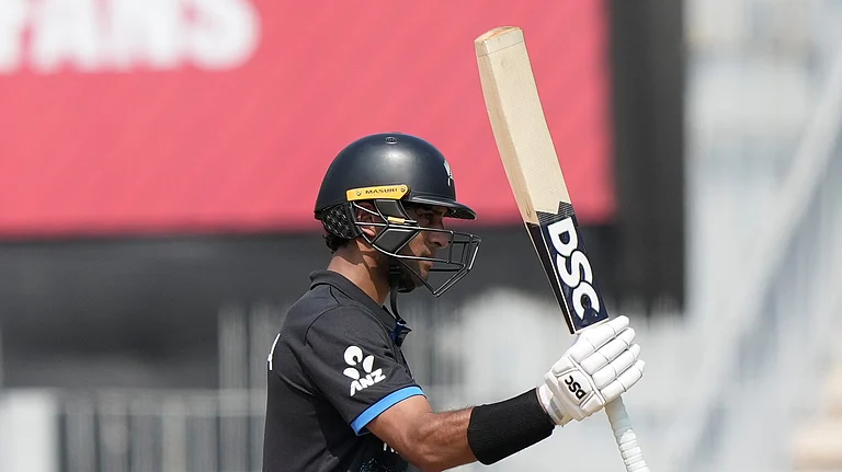 New Zealand's Rachin Ravindra celebrates his fifty runs during the T20 World Cup cricket match between Canada and New Zealand in Chennai, India, Tuesday, Feb. 17, 2026. - (AP Photo/Mahesh Kumar A.)