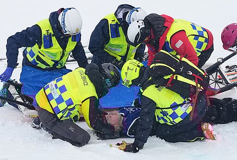 Medics respond after New Zealand's Finley Melville Ives crashed during the men's freestyle skiing halfpipe qualifications at the 2026 Winter Olympics, in Livigno, Italy.