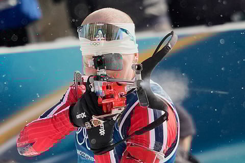 Norway's Johannes Dale-Skjevdal shoots during the men's biathlon 15-kilometers mass start race at the 2026 Winter Olympics, in Anterselva, Italy.