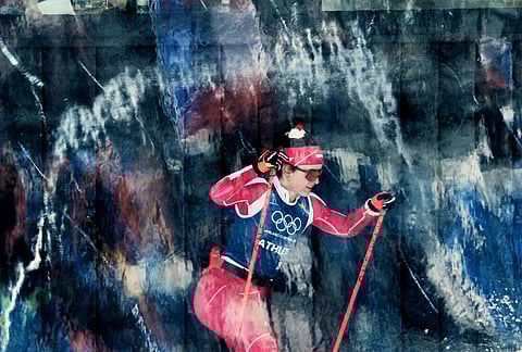 Poland's Anna Maka passes behind a glass wall while training on the biathlon course at the 2026 Winter Olympics, in Anterselva, Italy.