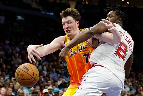 Charlotte Hornets guard Kon Knueppel (7) battles Houston Rockets forward Dorian Finney-Smith for the ball during the second half of an NBA basketball game in Charlotte, North Carolina.