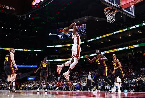 Miami Heat center Bam Adebayo (13) goes up to dunk against Atlanta Hawks center Jock Landale (31), forward Mouhamed Gueye (18), guard Keaton Wallace (2) and forward Zaccharie Risacher (10) during the second half of an NBA basketball game in Atlanta.