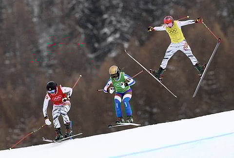From left, Switzerland's Talina Gantenbein (5), France's Jade Grillet Aubert (6) and Switzerland's Sixtine Cousin (13) compete during the women's ski cross finals at the 2026 Winter Olympics, in Livigno, Italy.