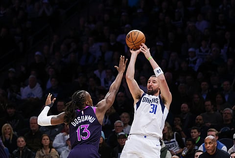 Minnesota Timberwolves' Ayo Dosunmu (13) defends against Dallas Mavericks' Klay Thompson (31) during the second half of an NBA basketball game in Minneapolis.