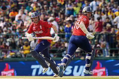 England's Phil Salt, left, and Sam Curran run between the wickets during the T20 World Cup cricket match between Sri Lanka and England in Pallekele, Sri Lanka.