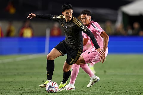 Los Angeles FC forward Son Heung-Min (7) dribbles against Inter Miami defender Ian Fray, back right, during the first half of an MLS soccer match in Los Angeles, Calif.
