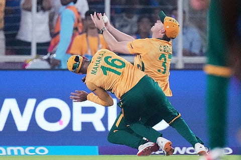 South Africa's Corbin Bosch, right, collides with teammate Keshav Maharaj as he takes the catch successfully to dismiss India's Abhishek Sharma during the T20 World Cup cricket match between India and South Africa in Ahmedabad, India.