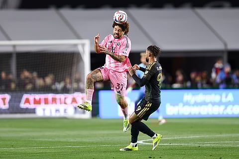 Inter Miami defender Maximiliano Falcón (37) heads the ball against Los Angeles FC forward Denis Bouanga, right, during the first half of an MLS soccer match in Los Angeles, Calif.